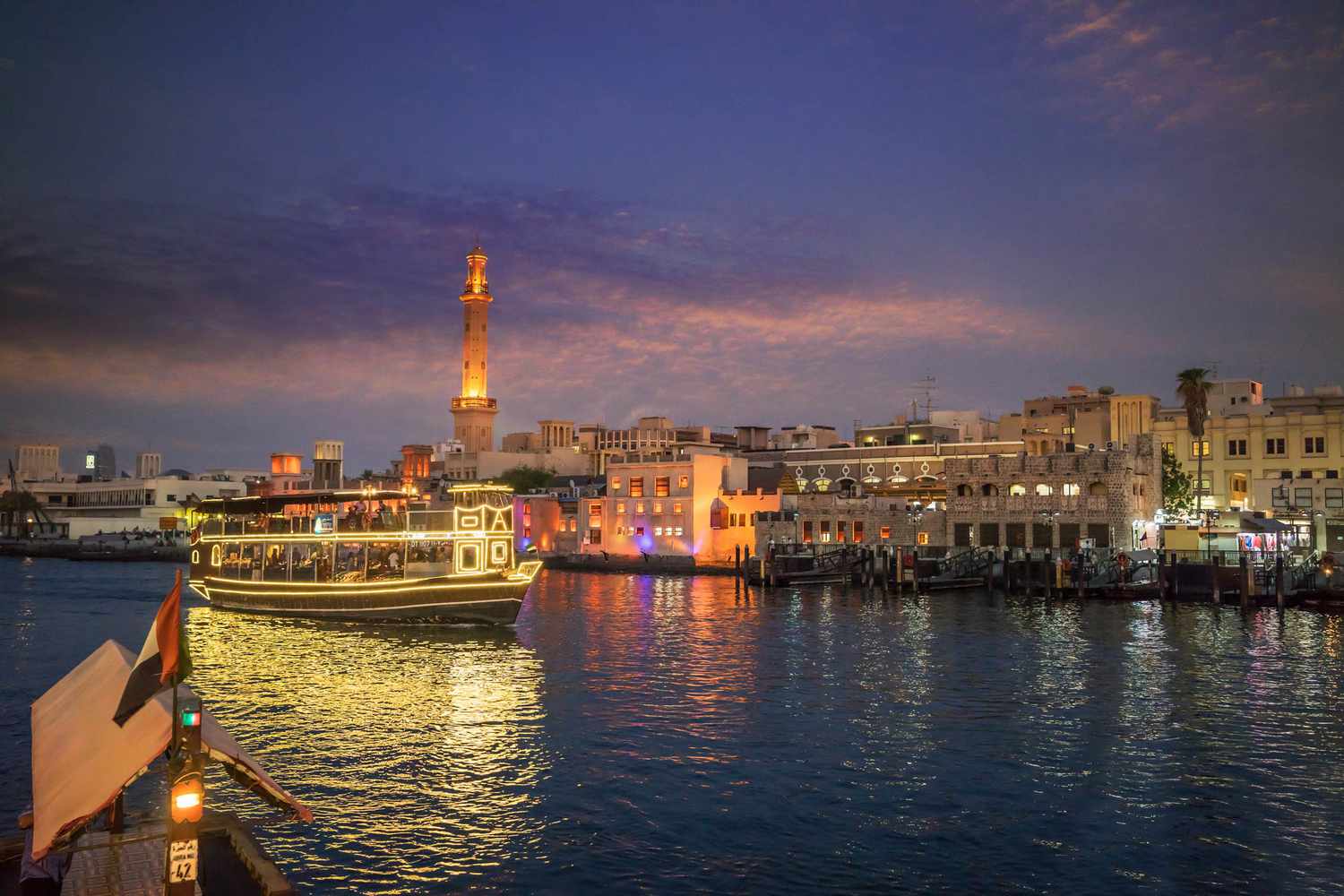 A ferry going down the Dubai Creek at night