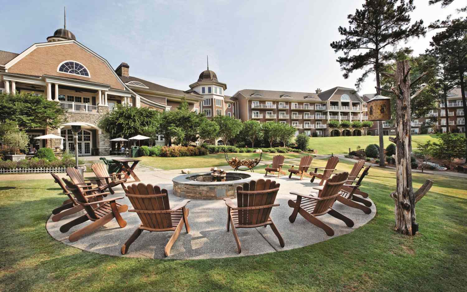 Adirondack chairs surrounding an outdoor fire pit