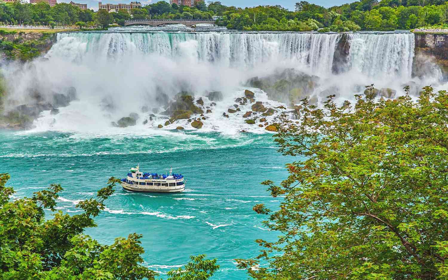 A Maid of the Mist boat is seen passing by the base of Niagara Falls.