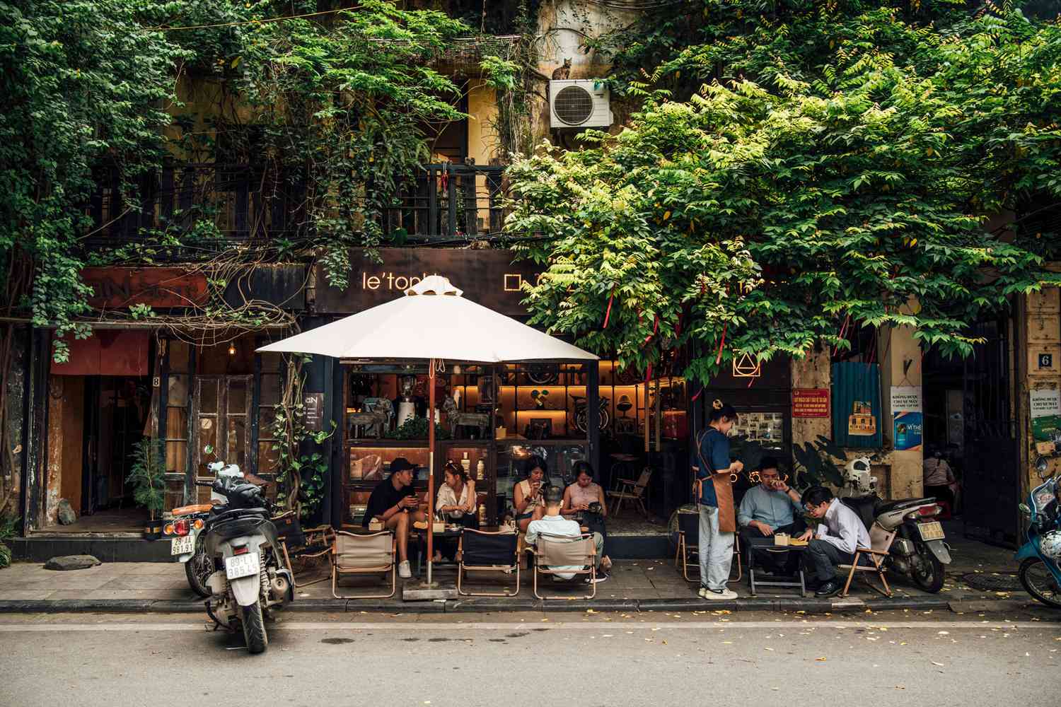 People sitting outside at a cafe on the streets of Hanoi